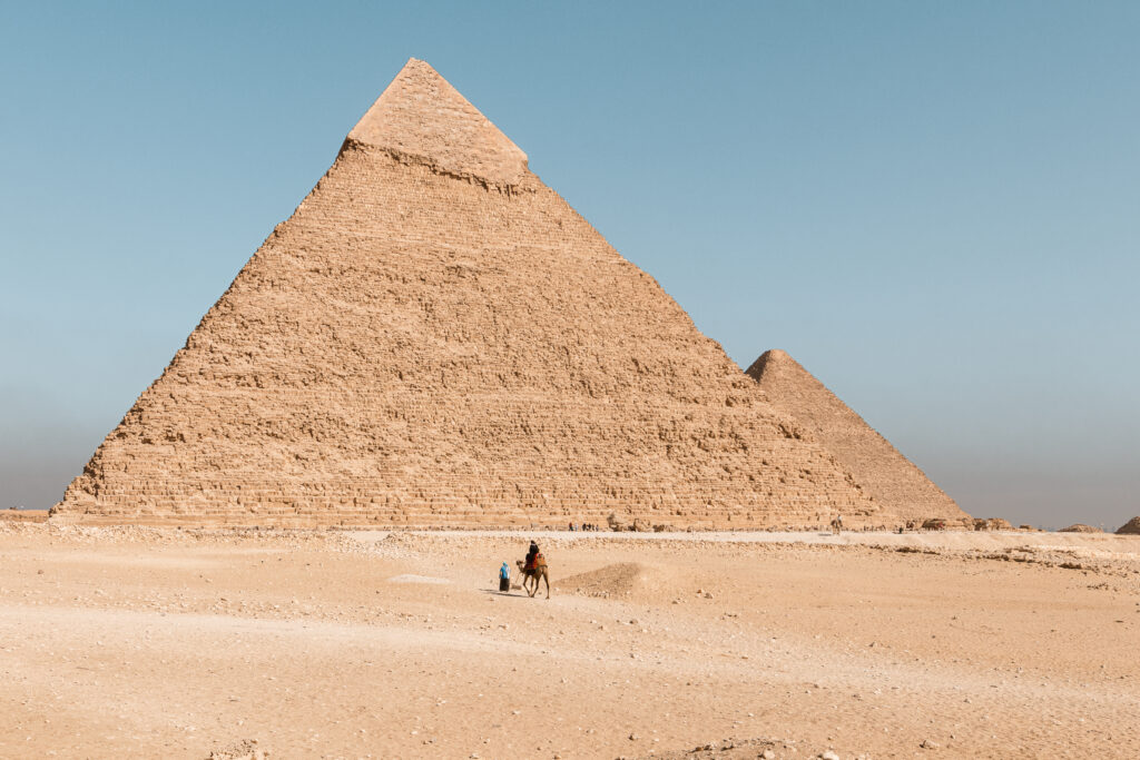 Pyramid of Khafre with Great Pyramid in the distance and a camel in the front