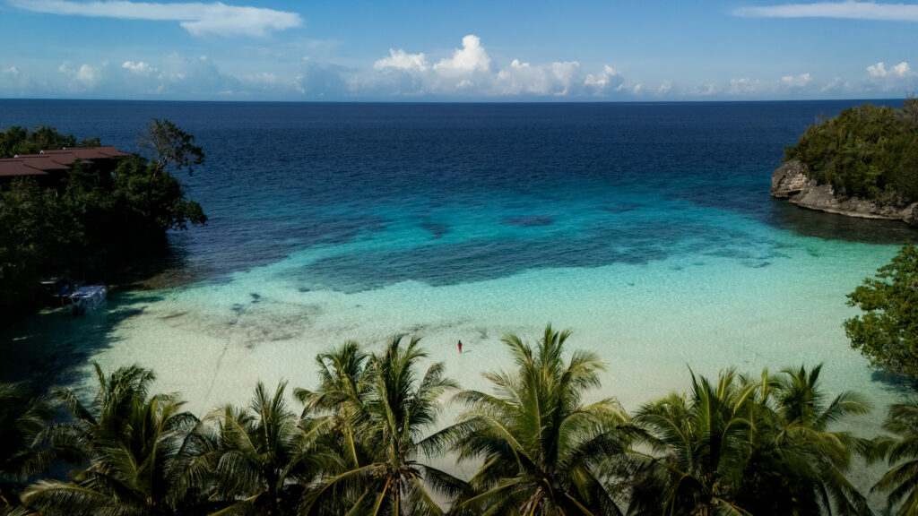 Aerial view of Turquoise-water Bay in Malenge, Togean Islands, Indonesia